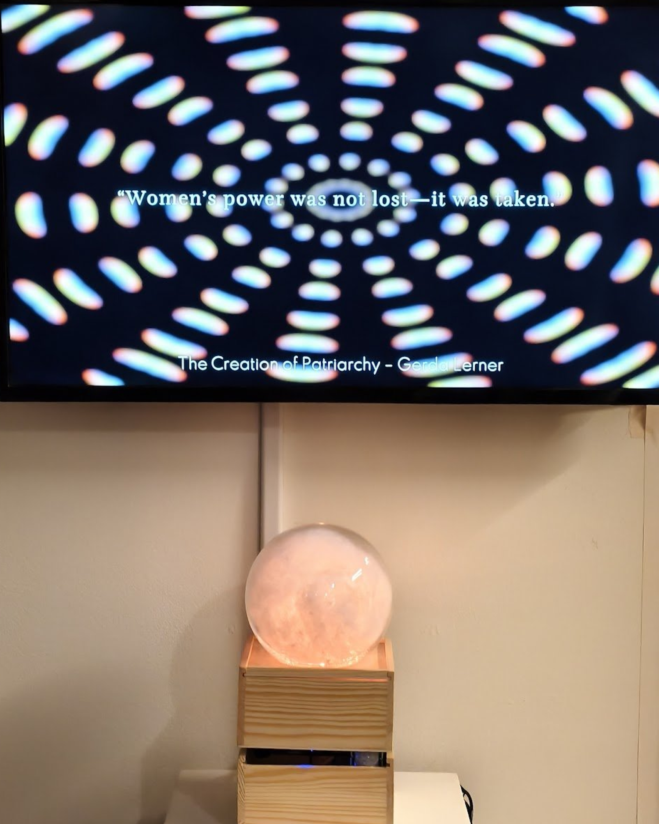 Vibe Altar crystal ball glowing rose-pink during Gerda Lerner invocation at Every Woman Biennial 2026